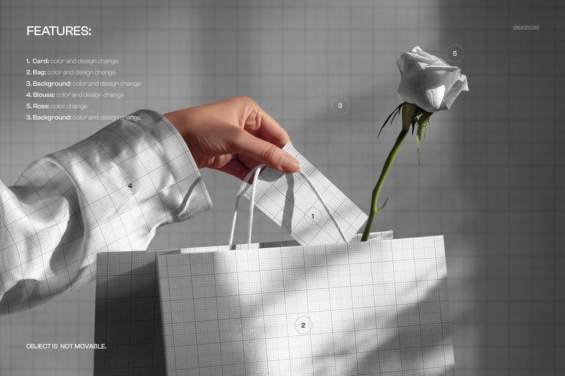 PSD mockup showing a hand holding a card above a grid-patterned gift bag with a white rose, viewed from the front.