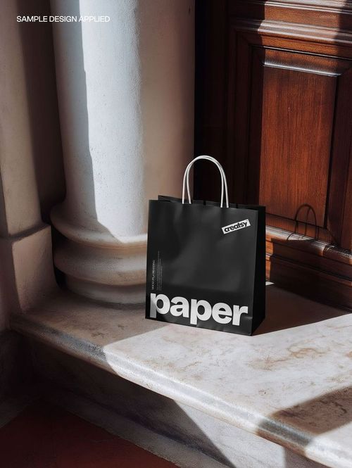 Paper shopping bag mockup with bold white text, set on marble steps near a wooden door, front perspective.
