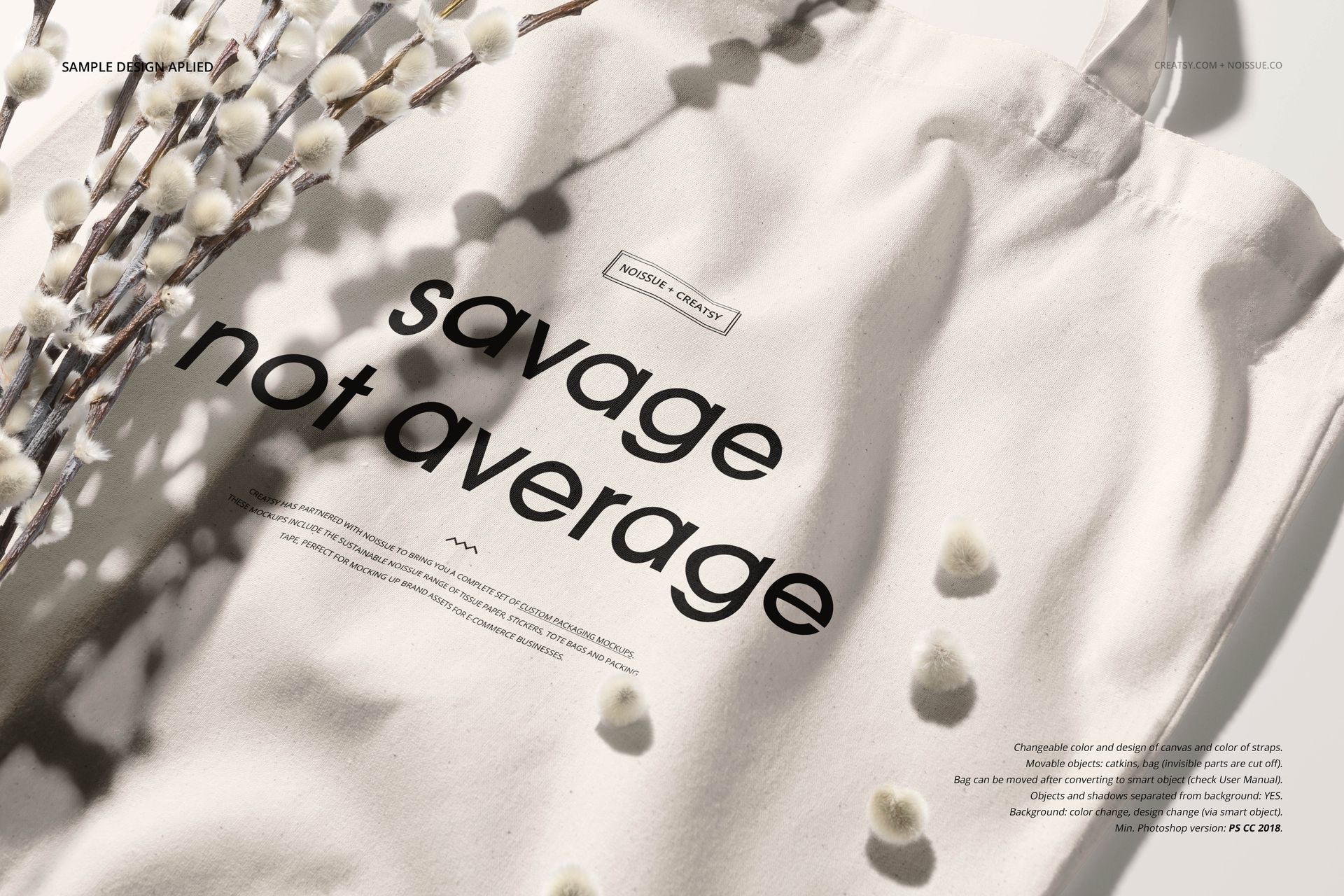 Cream-colored tote bag mockup with bold black text on the front, displayed in natural light with pussy willow branches.