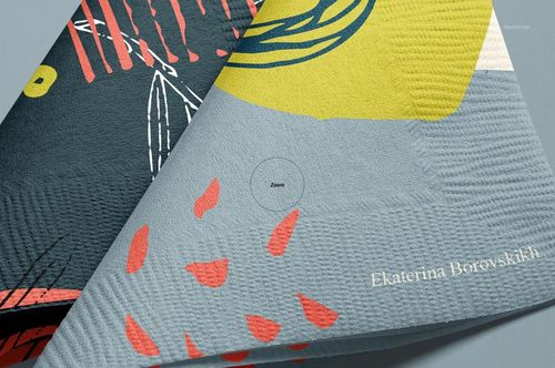 Abstract patterned paper napkins mockup showing folded corners, with visible textures and colorful geometric designs.