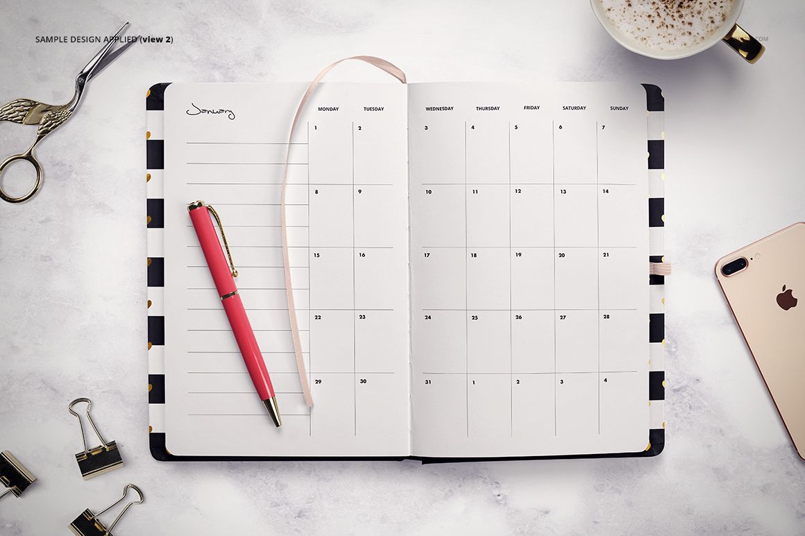 Top view of an open planner mockup with a monthly calendar layout, surrounded by office supplies and a cup of coffee.