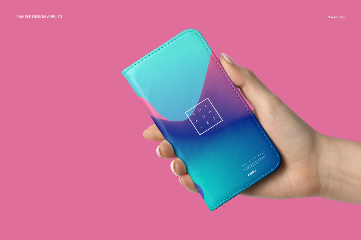 Foldable iPhone case mockup featuring a vibrant blue and pink pattern, displayed in hand over a solid pink backdrop.