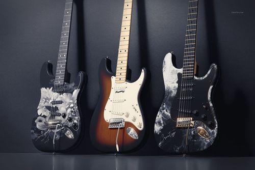 Electric guitar PSD mockup showing trio of guitars with varied finishes, photographed from the front in a studio setting.