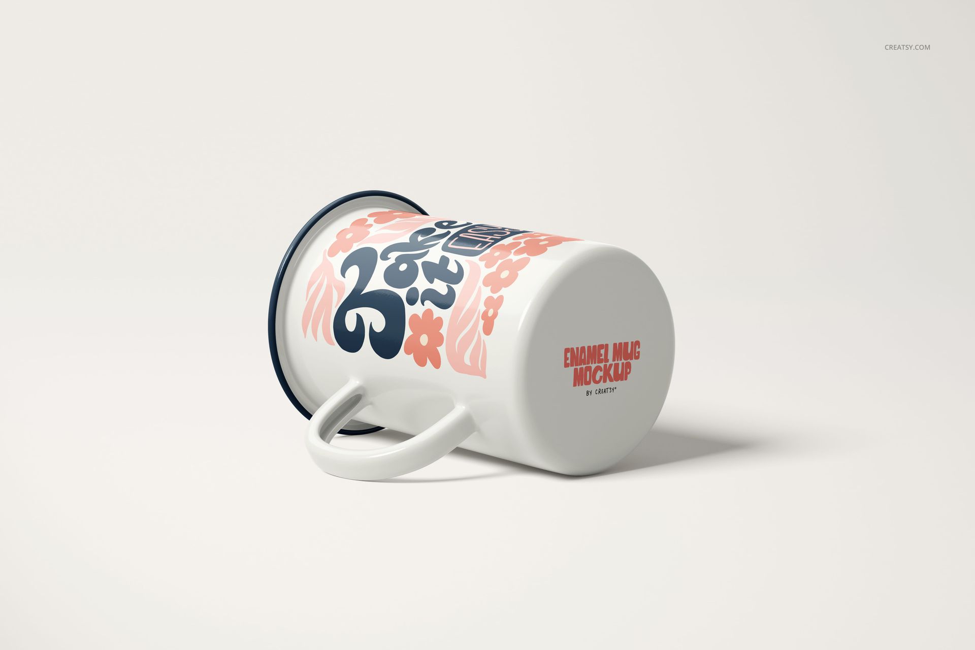 Enamel mug mockup with a handle, decorated with pink flowers and blue text, shown from a side angle.