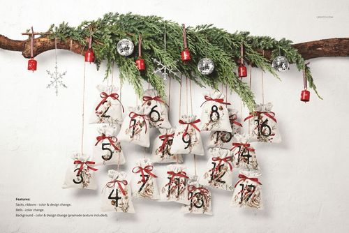 Christmas advent calendar mockup featuring numbered drawstring sacks hanging from a branch with pine greenery and ornaments.