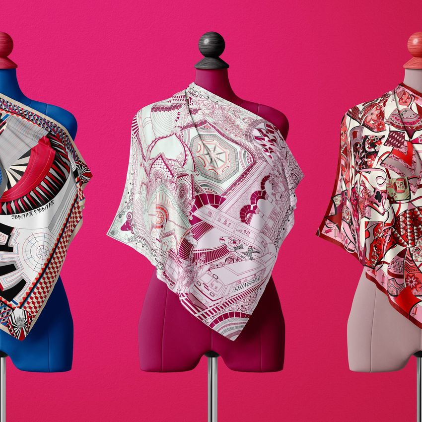 A fashion accessories mockup shows three mannequins draped in patterned silk scarves, set before a bright pink wall.