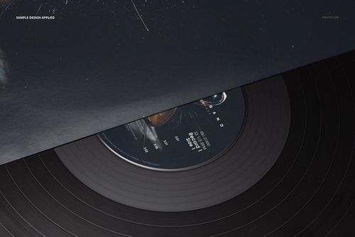 Black vinyl record mockup with detailed grooves, partially hidden under a dark cover, seen from above.