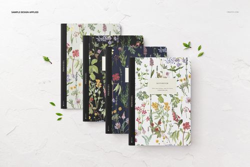 PSD mockup showing four notebooks with various botanical designs, displayed in a flat lay arrangement on a white background.