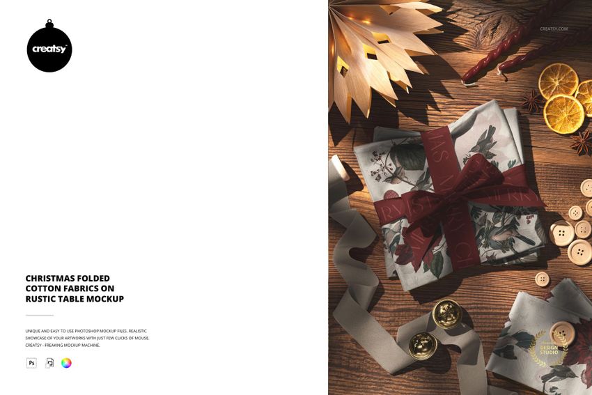 Christmas folded cotton fabrics mockup featuring festive patterns, ribbon, and holiday props on a wooden surface.
