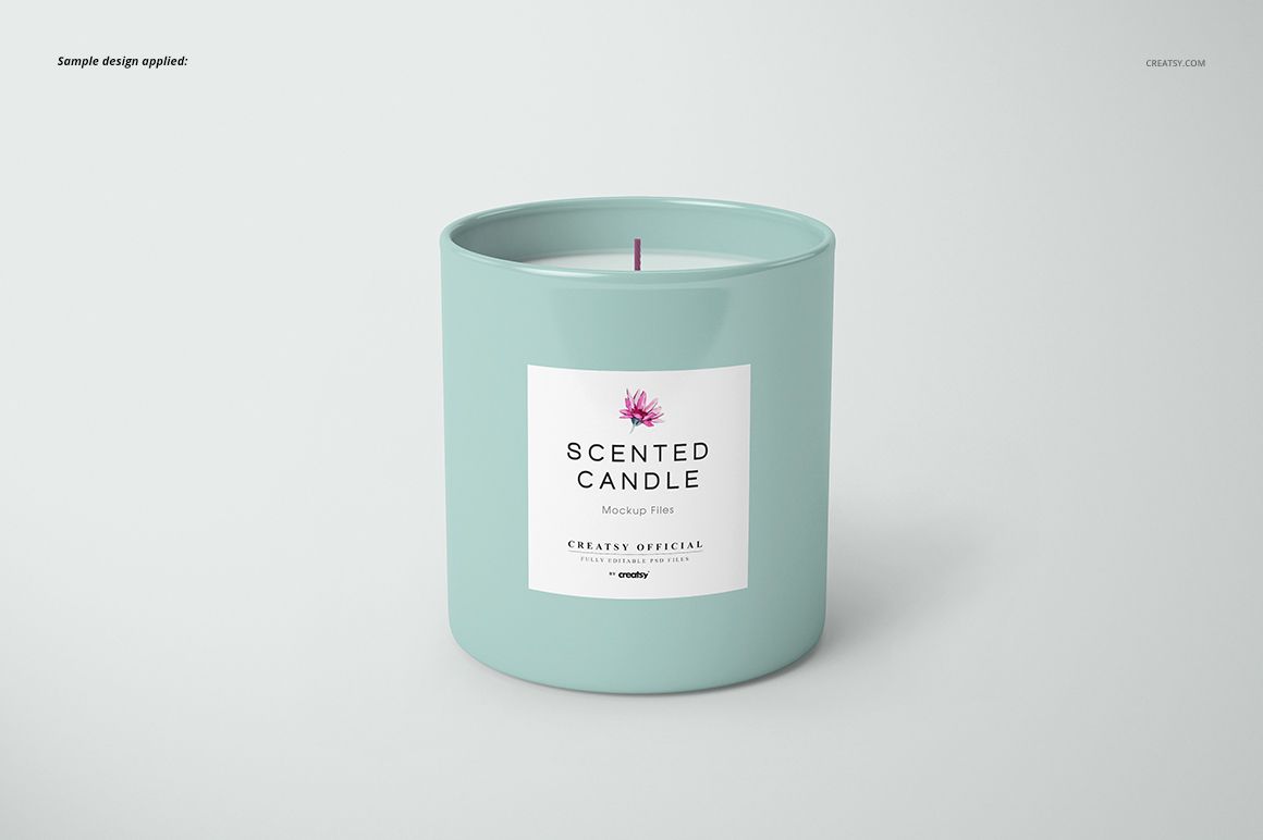 Cylindrical candle mockup in a solid pastel blue jar, featuring a centered label and visible wick, set against a plain backdrop.