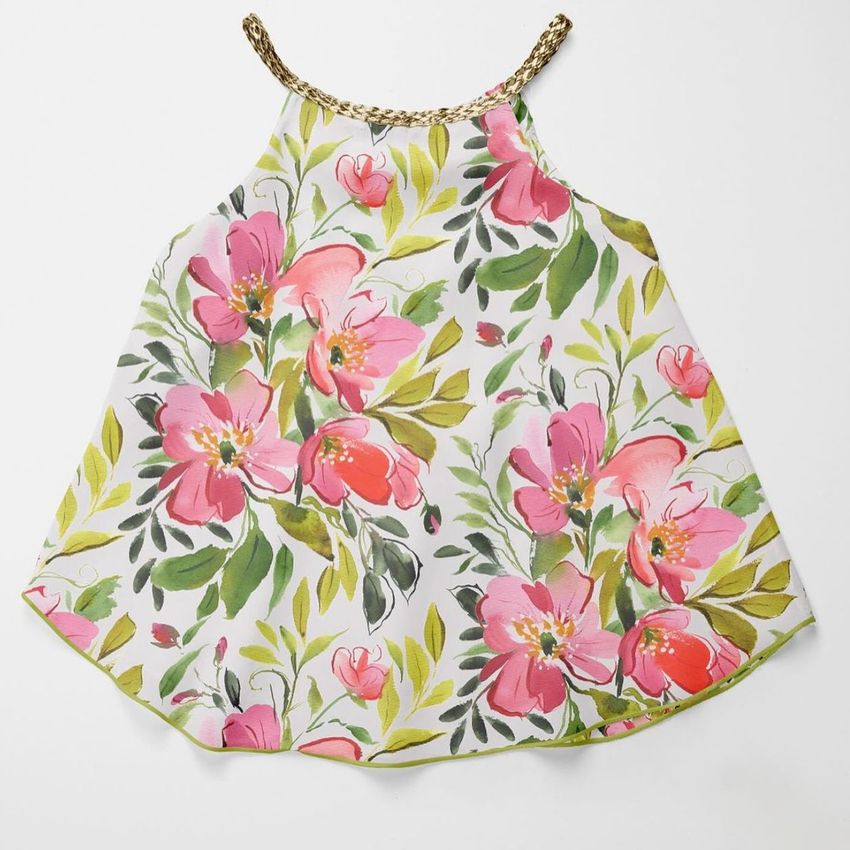 Baby summer set mockup featuring a sleeveless dress with a large pink floral pattern on a white background, viewed from above.