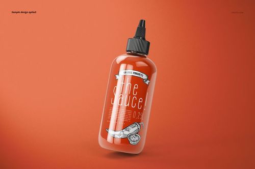 Floating sauce bottle mockup with transparent body and black nozzle cap, displayed against a solid orange backdrop.
