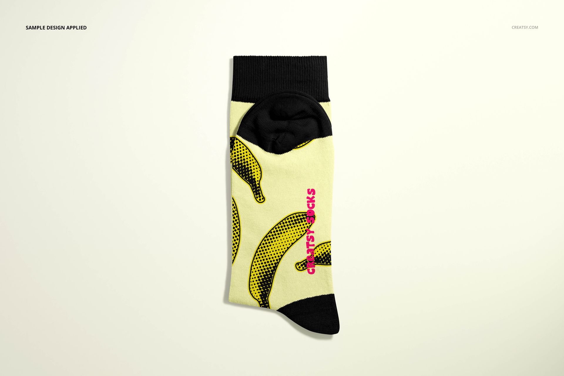 Medium cuff sock mockup featuring a yellow sock with black cuff and banana pattern, shown from top view on a light background.