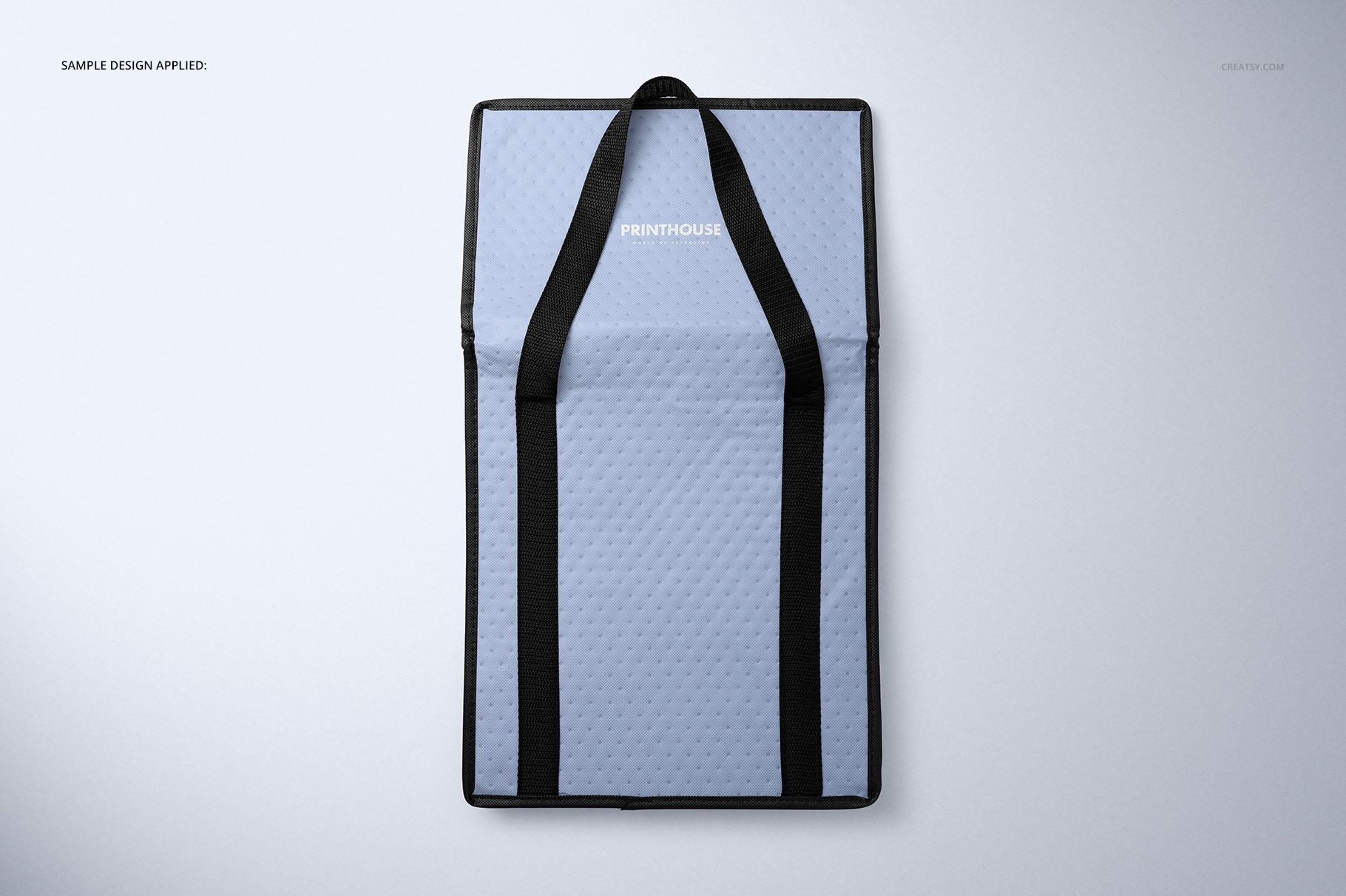 Rectangular insulated cooler bag mockup shown from above, featuring a quilted light blue exterior and black straps.