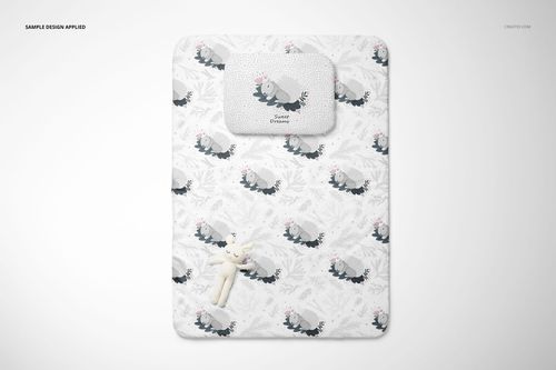 Double-sided baby bedding mockup with pillow and quilt, showing playful gray animal design on a white surface.