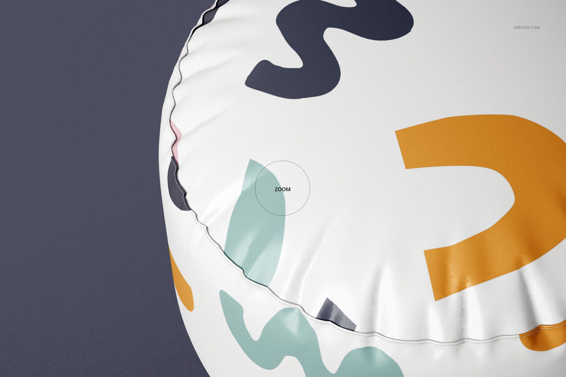 Close-up of a round pouf mockup with multicolored abstract patterns on white, set against a dark plain background.