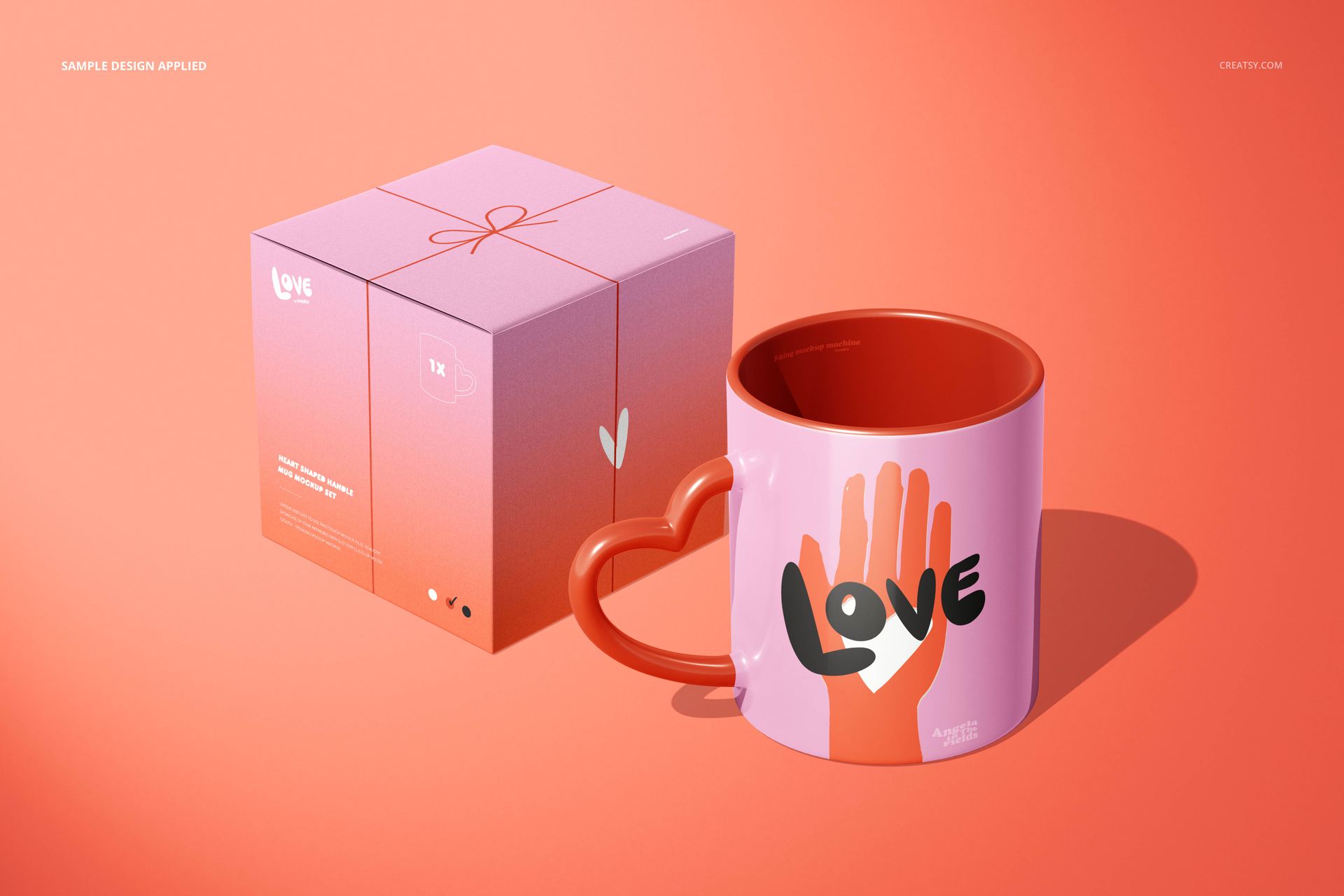 PSD mockup featuring a heart-handle mug in pink and orange, with a graphic design, displayed beside a gift box.