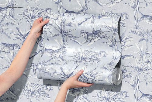 Front view of a wallpaper mockup displaying a rolled sheet with a botanical and tiger motif in soft blue tones.