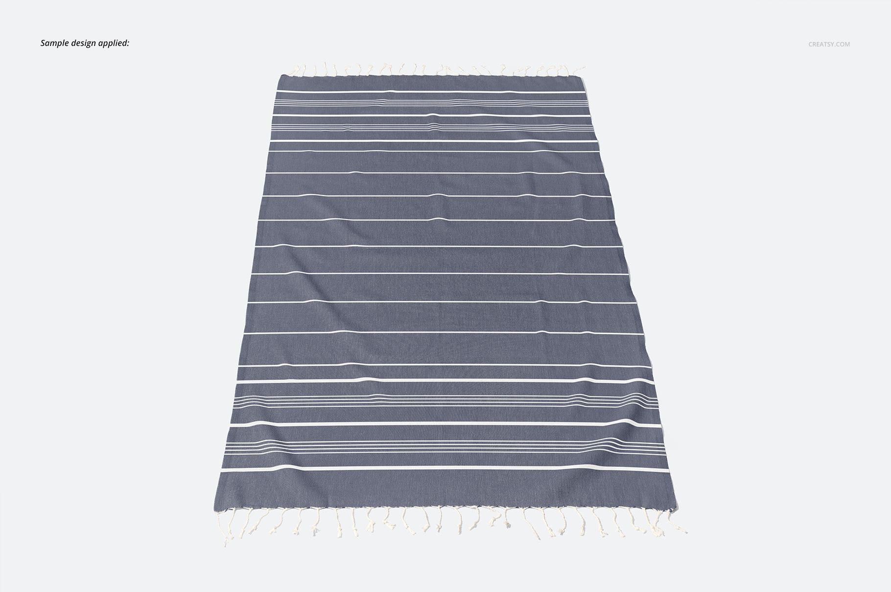 Flat lay of a Turkish tassel towel mockup featuring white horizontal stripes on a solid gray surface.