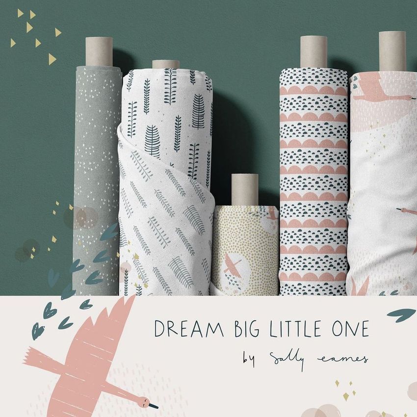 Fabric rolls mockup showing six upright rolls with pastel patterns, set against a green wall with a decorative panel below.