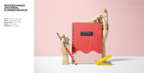 Spiral-bound planner mockup with red patterned cover, wooden hands, pencil, and yellow stapler against a pink background.
