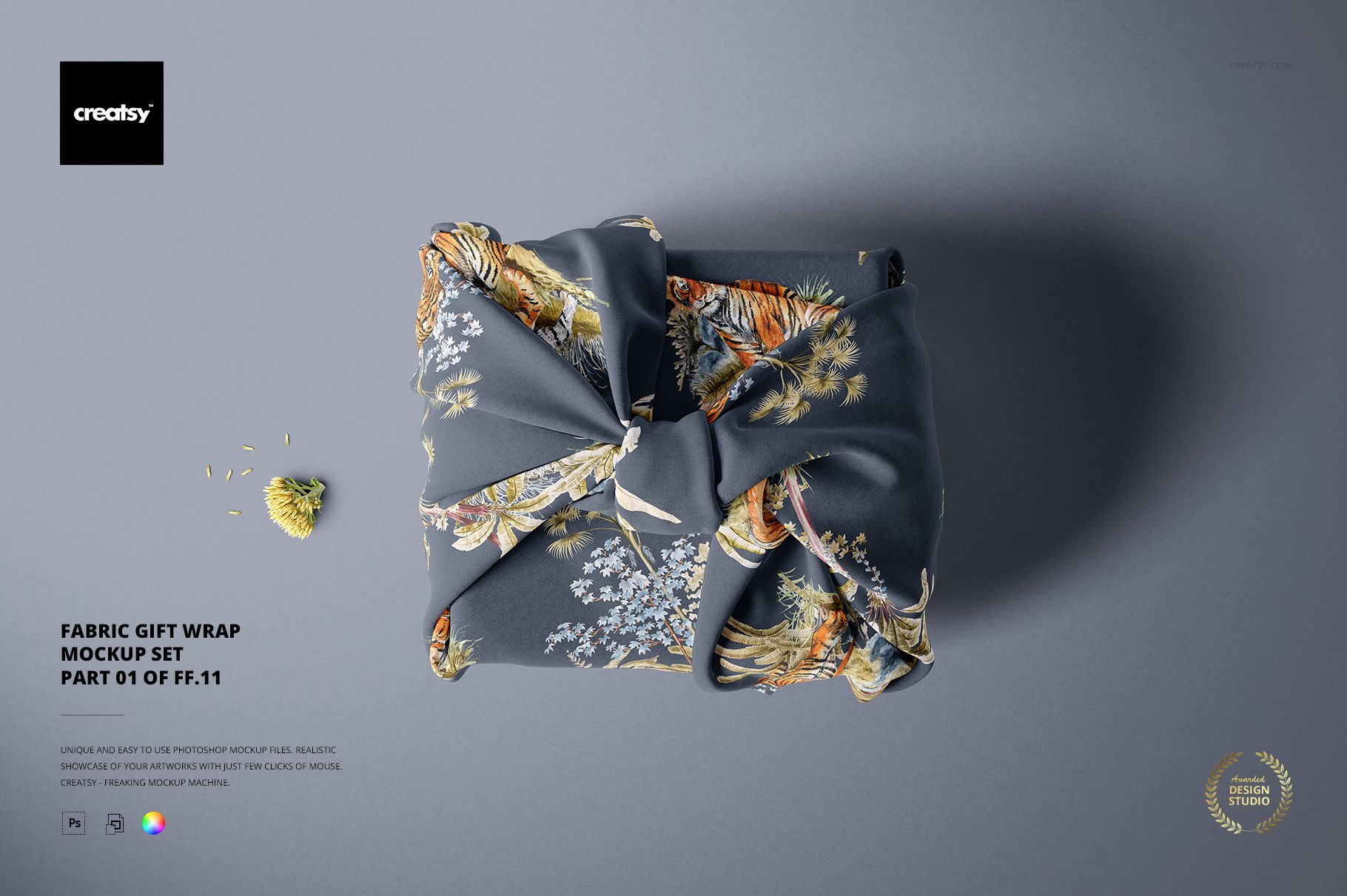Rectangular fabric gift wrap mockup featuring a dark floral and animal print, knotted in the center, seen from above.