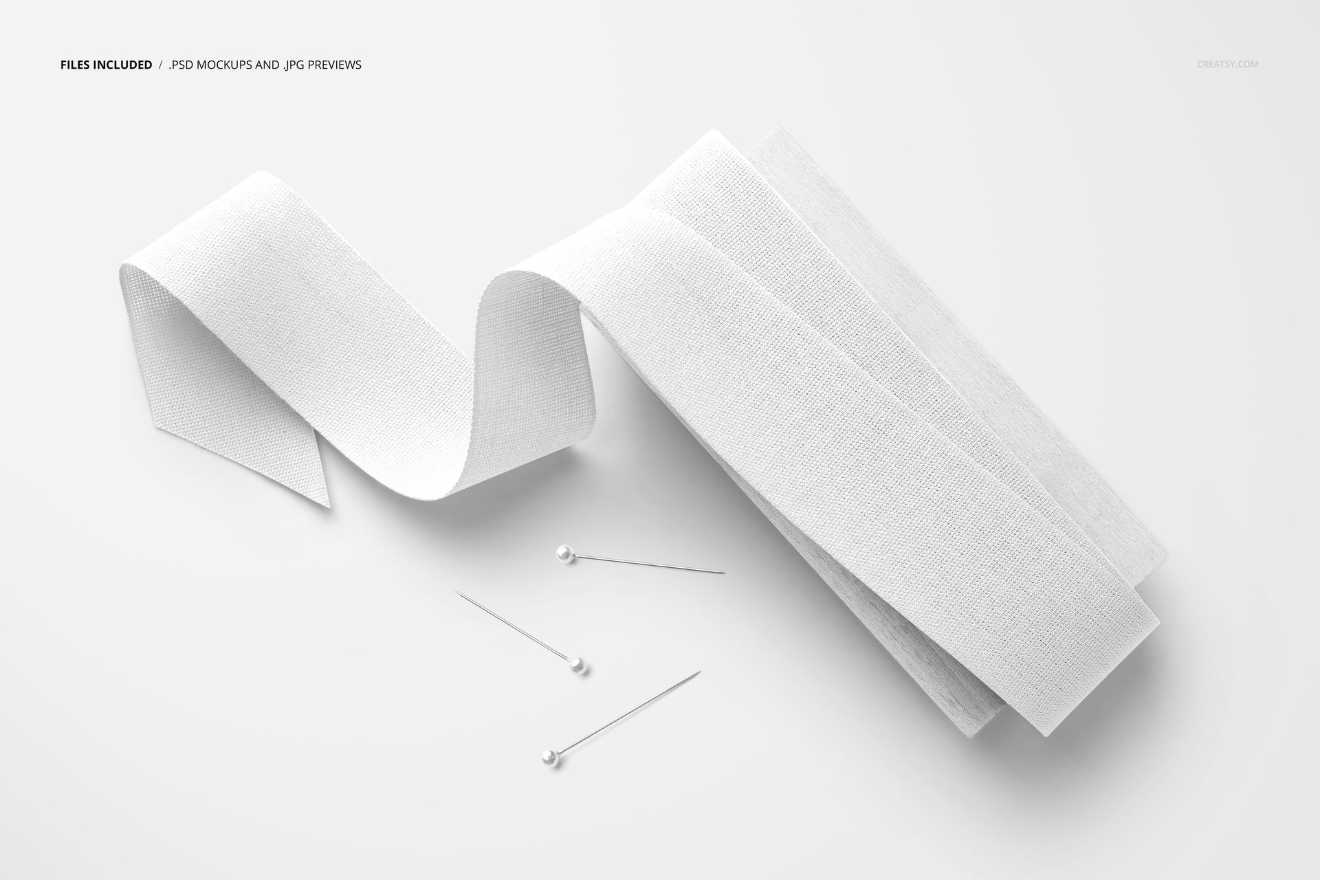 White cotton ribbon mockup arranged on a wood paddle, viewed from above with pins placed nearby on a light surface.