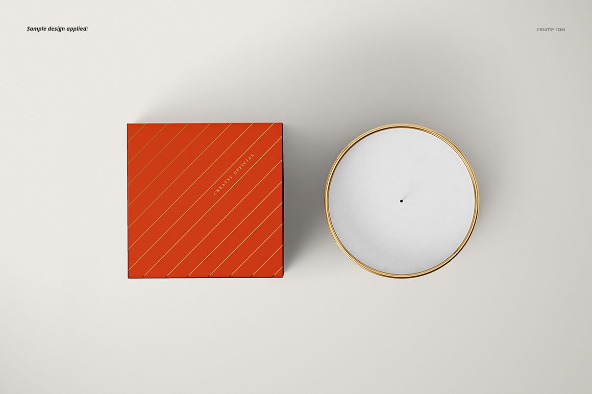 Classic candle mockup featuring a round metallic candle and an orange striped box, both seen from above on a light surface.