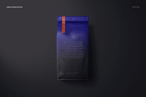 Matte finish coffee bag mockup with a dark blue and black gradient design, viewed from above on a dark surface.