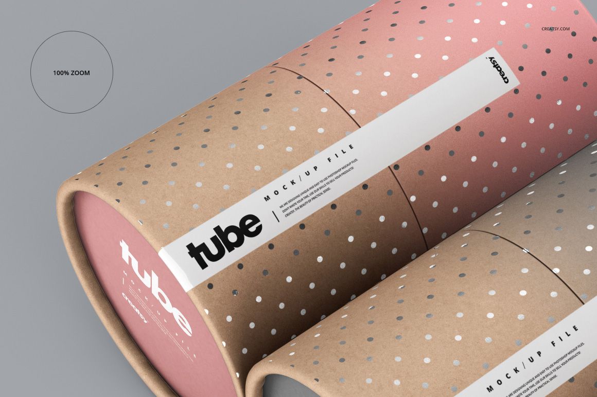 Close-up of paper tube packaging mockup showing brown and pink gradient surfaces with dotted patterns and white labels.