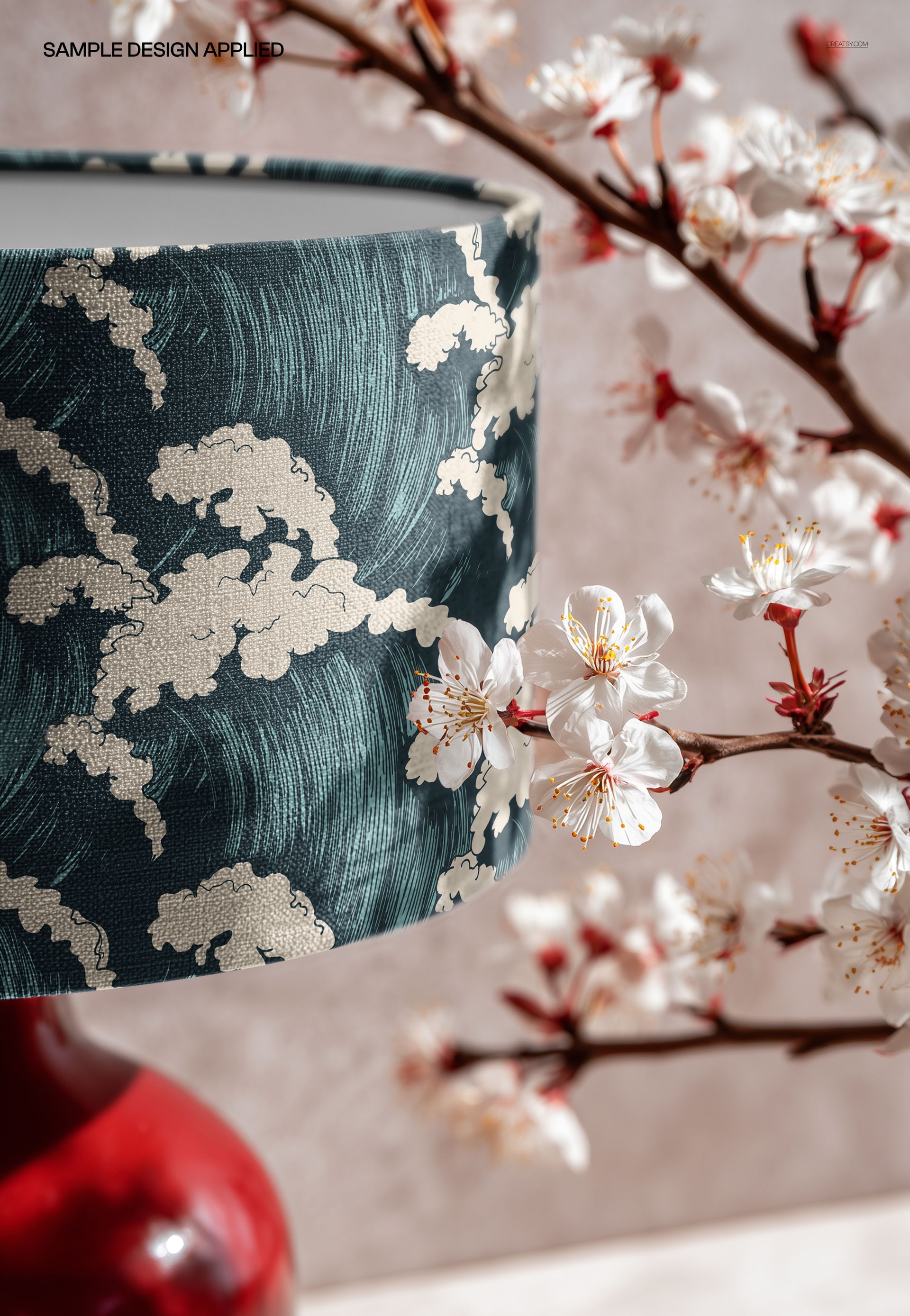 Close-up of a table lamp mockup featuring a textured floral lampshade and white blossom branches in the background.