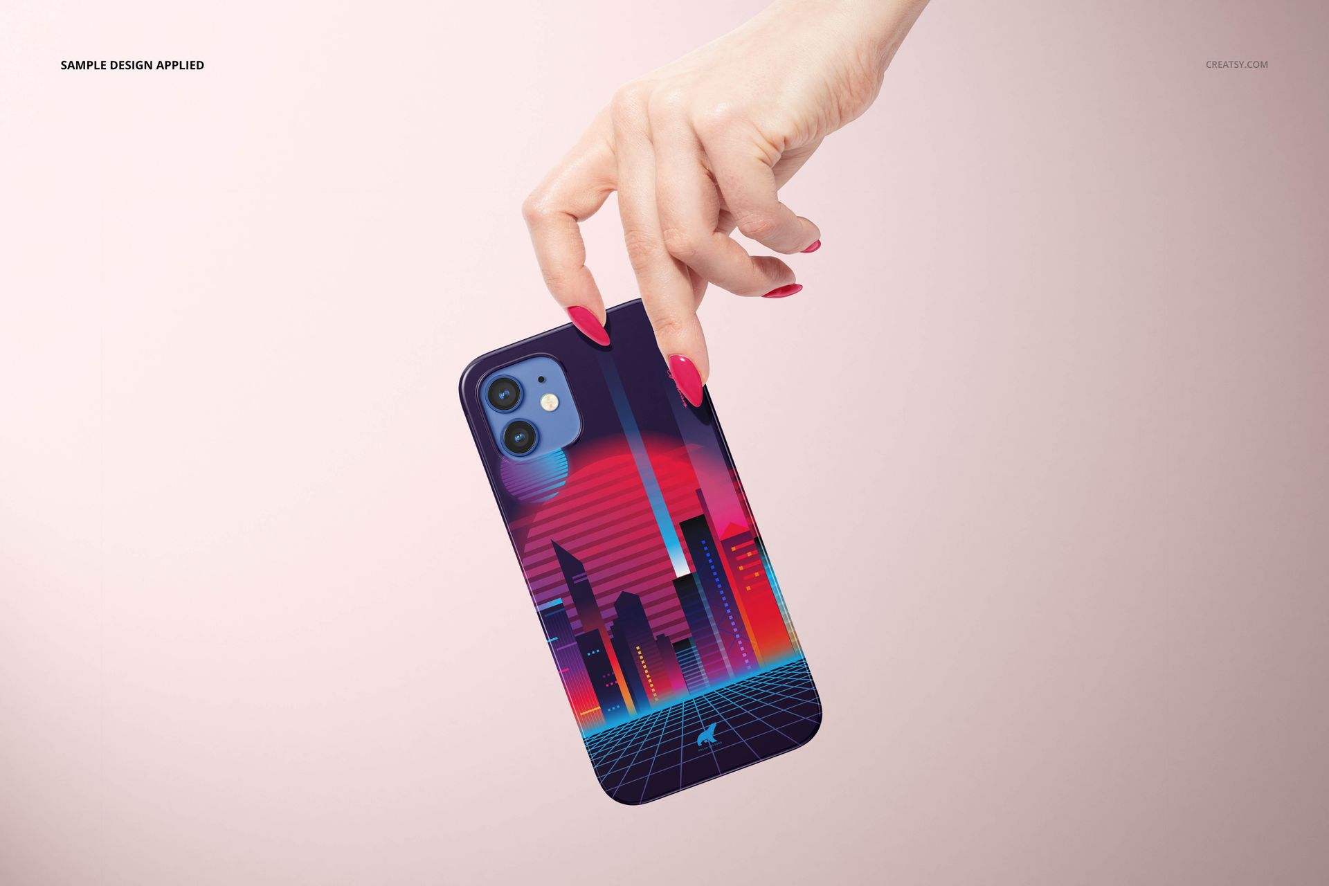 Close-up of a hand with matching pink nails holding a navy blue iPhone 12 in a glossy mockup case with neon city art.