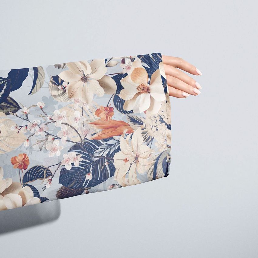 Chiffon kimono mockup showing a hand extended from a sleeve with a blue and beige floral pattern against a plain background.