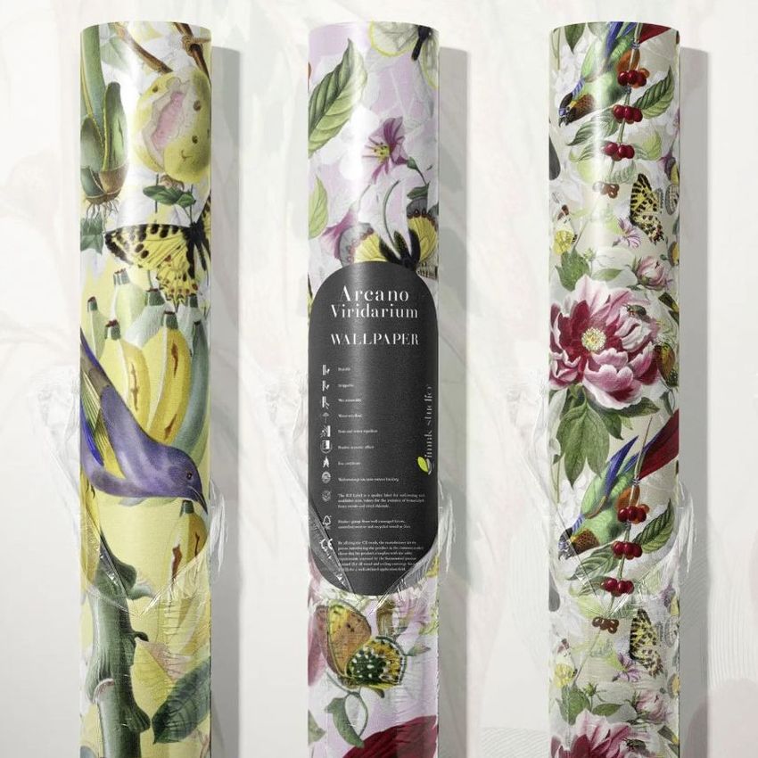 Gift wrapping paper mockup featuring three rolled sheets with botanical and bird illustrations in soft, natural colors on a light background.