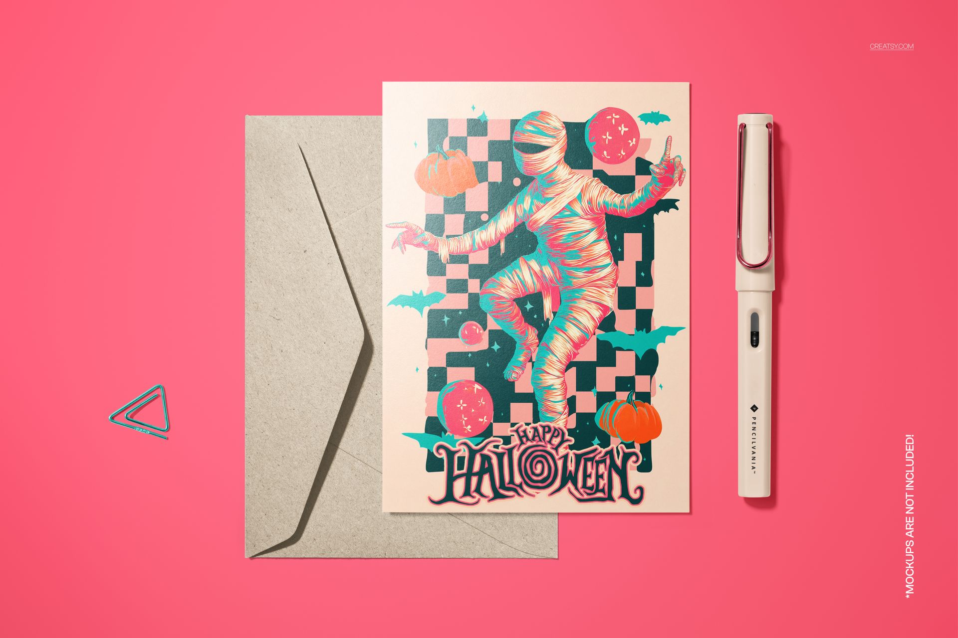 Halloween-themed 5x7 card mockup with a dancing mummy, pumpkins, and checkered pattern, shown with envelope and pen.
