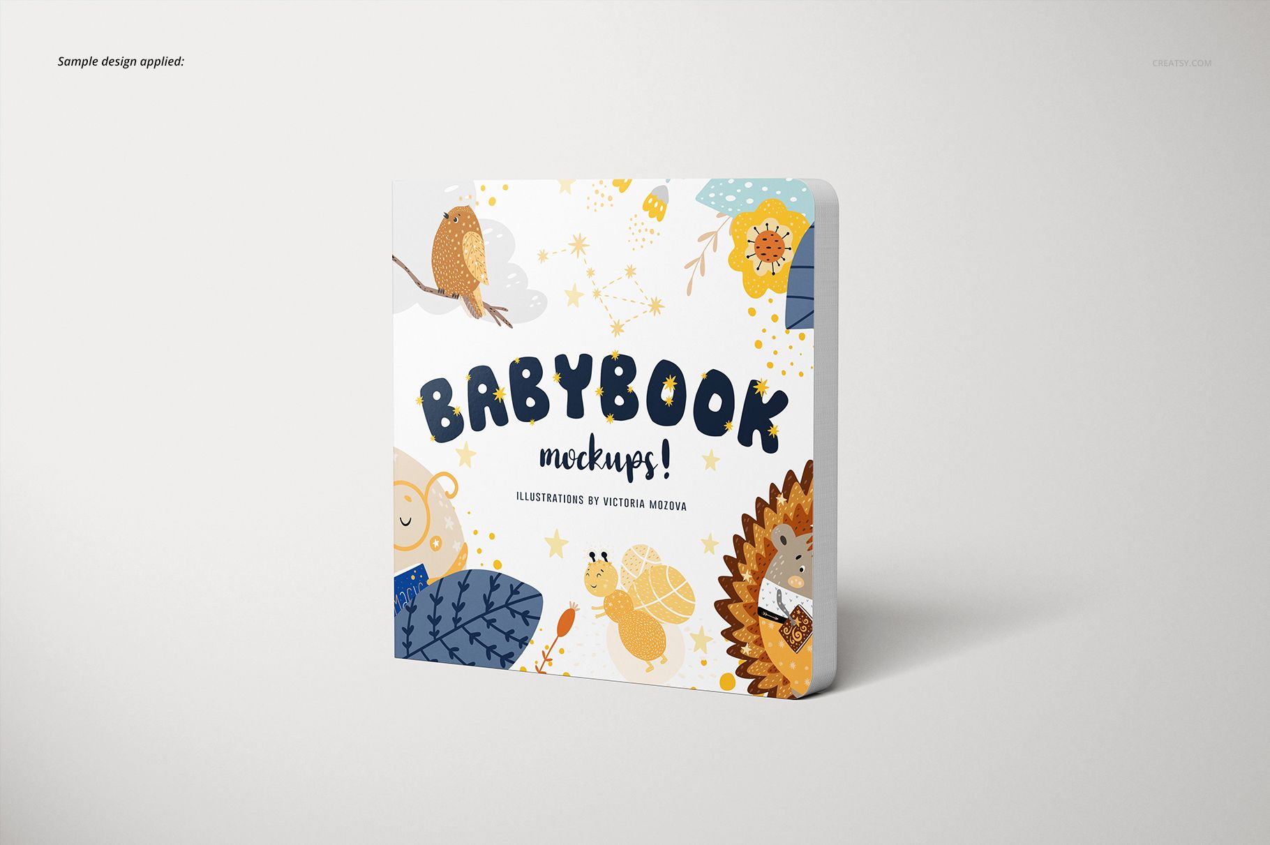 Cardboard baby book mockup standing upright with whimsical animal illustrations and blue, yellow, and orange accents.