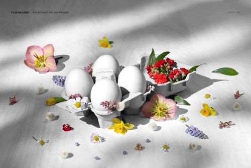 PSD mockup showing eggs in a carton with various spring flowers and blossoms placed around them on a bright tabletop.