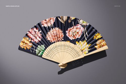 PSD mockup of a fabric hand fan with vibrant flower designs and light wooden elements shown from above.