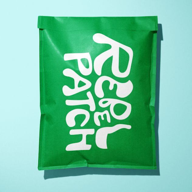 Green kraft bubble mailer mockup displayed on a light blue background, featuring bold white text on the front.