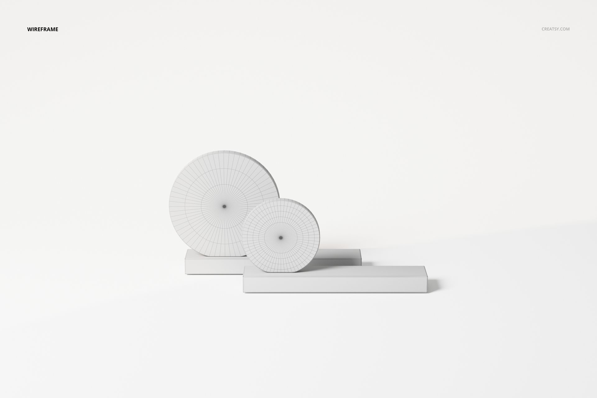 Front view of two abstract table decorations with circular geometric shapes on rectangular bases, white background.