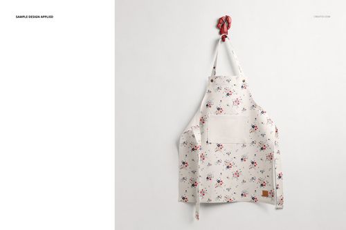Floral-patterned kids apron mockup shown from the front, hanging on a wall with a red hook and neutral background.