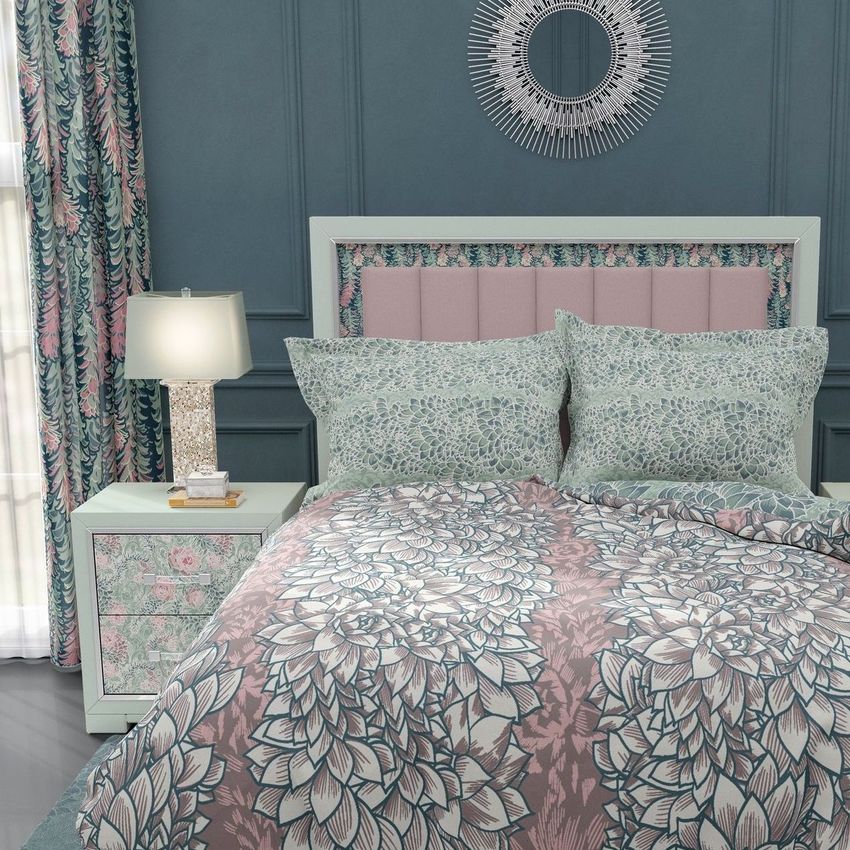 Luxury bedroom bedding mockup featuring flanged pillows, a patterned comforter, and matching curtains in a pastel floral design.