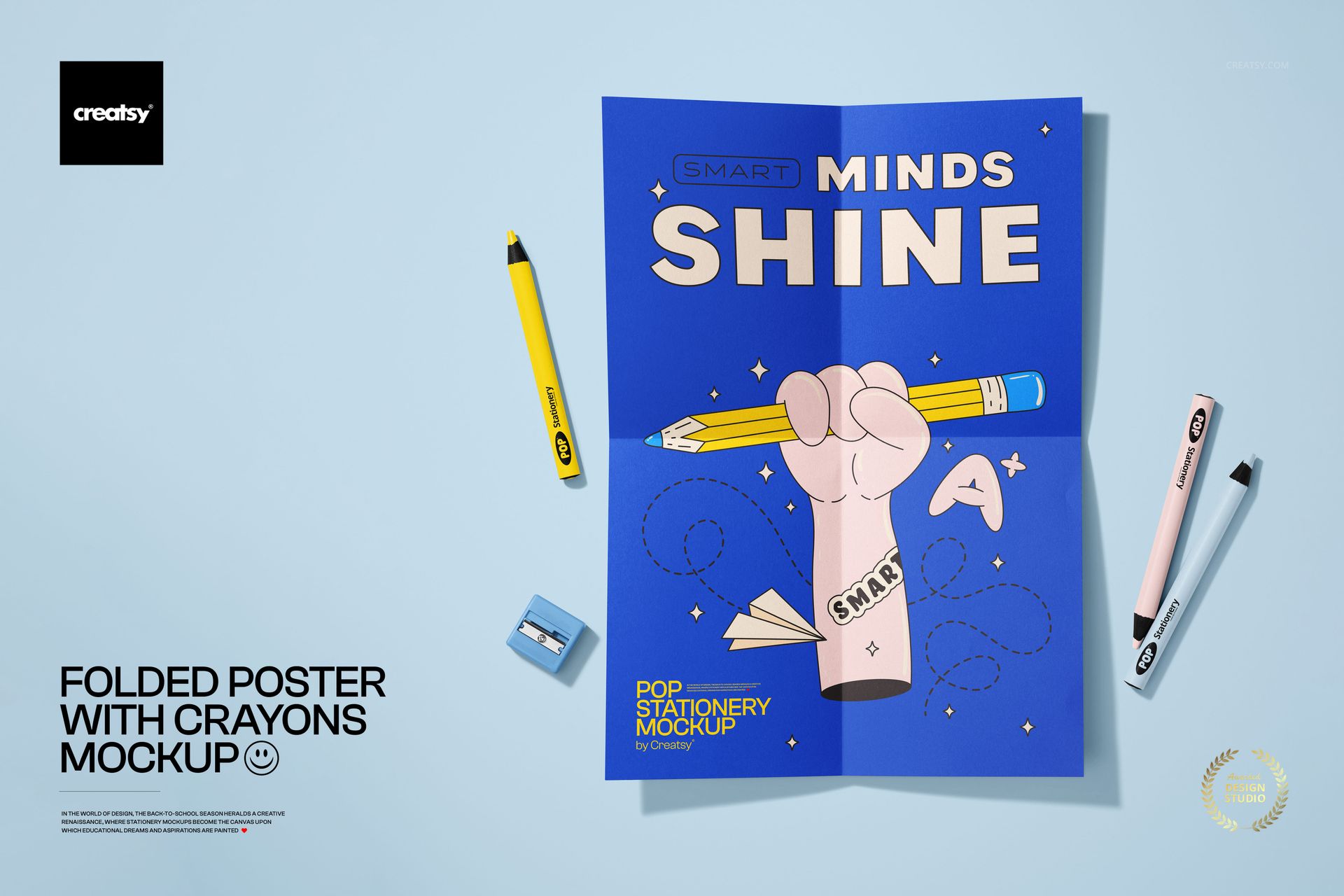 Folded poster mockup with a bold blue background, surrounded by yellow and pink crayons and a pencil on a flat surface.