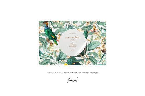 Floating square silk scarf mockup featuring a botanical pattern with green leaves and colorful birds, front view.