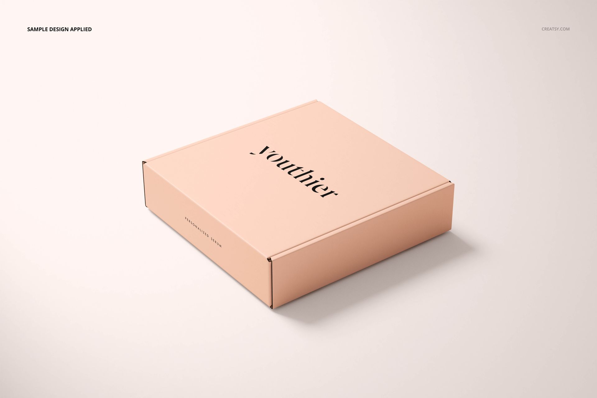 Light peach square packaging box mockup with simple black lettering, displayed at a slight angle on a neutral surface.