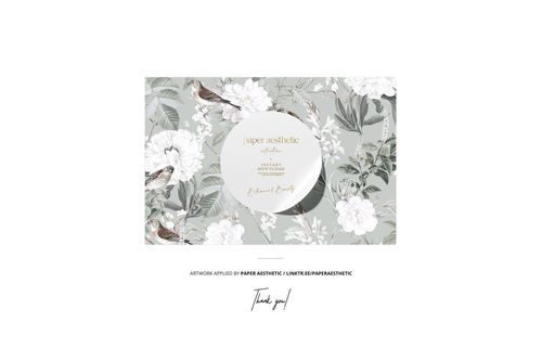 Mockup of a rectangular reading pillow displaying white flowers and birds on muted green, shown from the front.