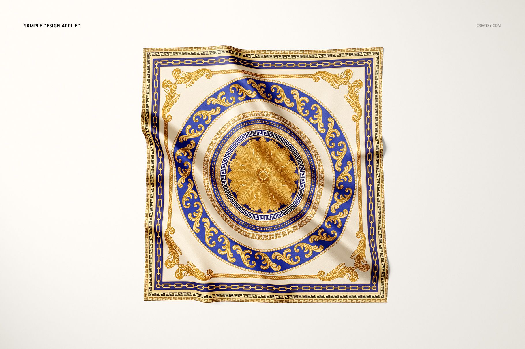 Satin scarf mockup featuring an intricate gold and blue decorative motif, shown from a top perspective on white.