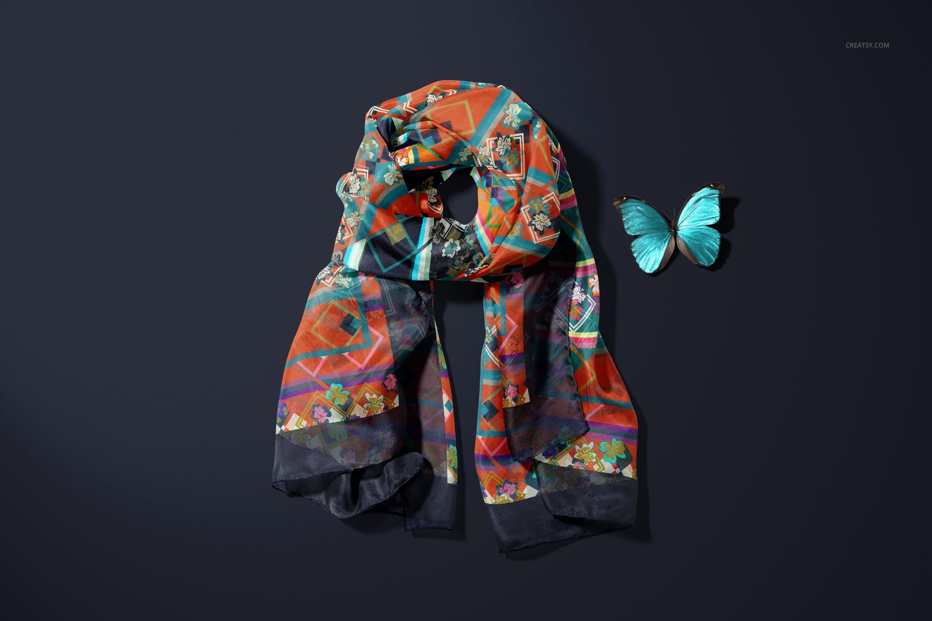 Habotai silk scarf mockup featuring vibrant abstract and floral designs, laid flat next to a turquoise butterfly.