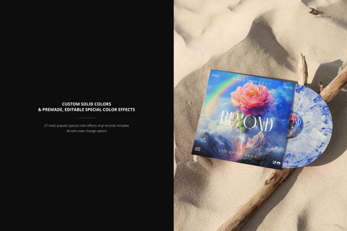 PSD mockup showing a vinyl record and album cover featuring a vivid flower design placed on sandy terrain with a wooden stick.