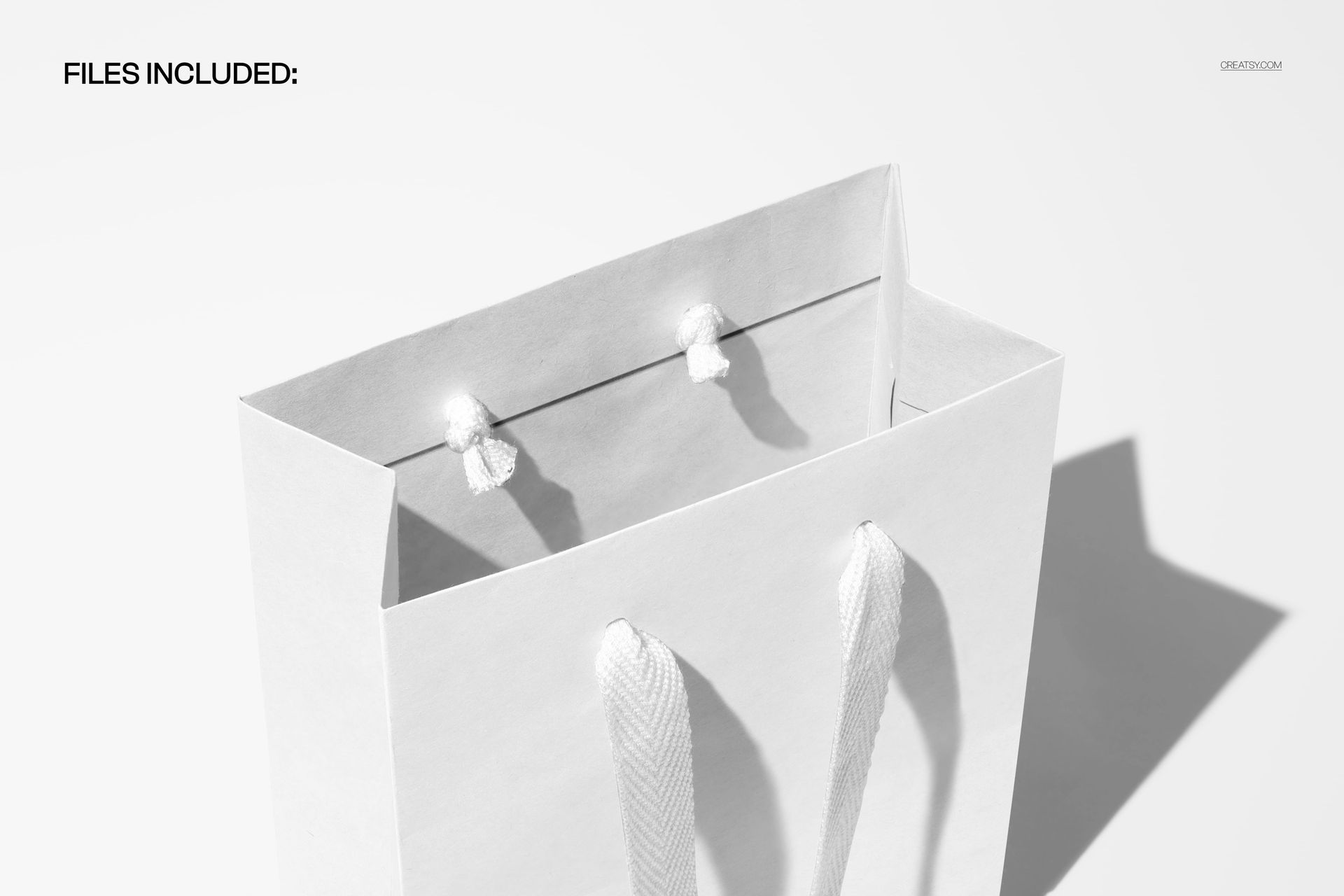 Paper shopping bag mockup shown from above, featuring white textured handles and soft studio shadows on a plain surface.